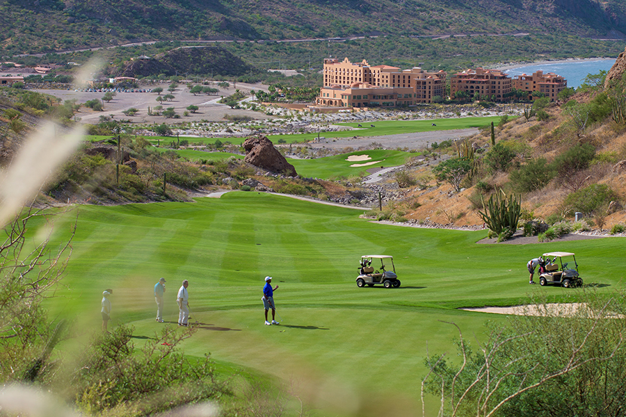 golf cart and players at tpc danzante bay at the islands of loreto golf course