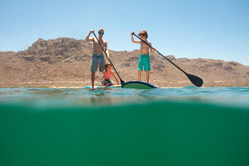 kids paddling at villa del palmar loreto beach