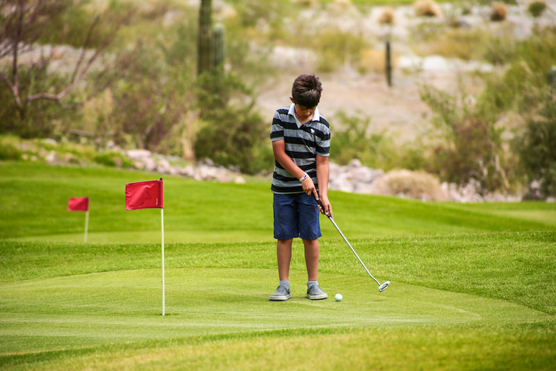 kid playing at tpc danzante bay putting course