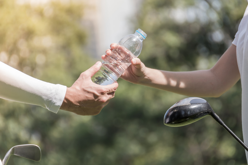 drinking water on the golf course - hydration during summer heat